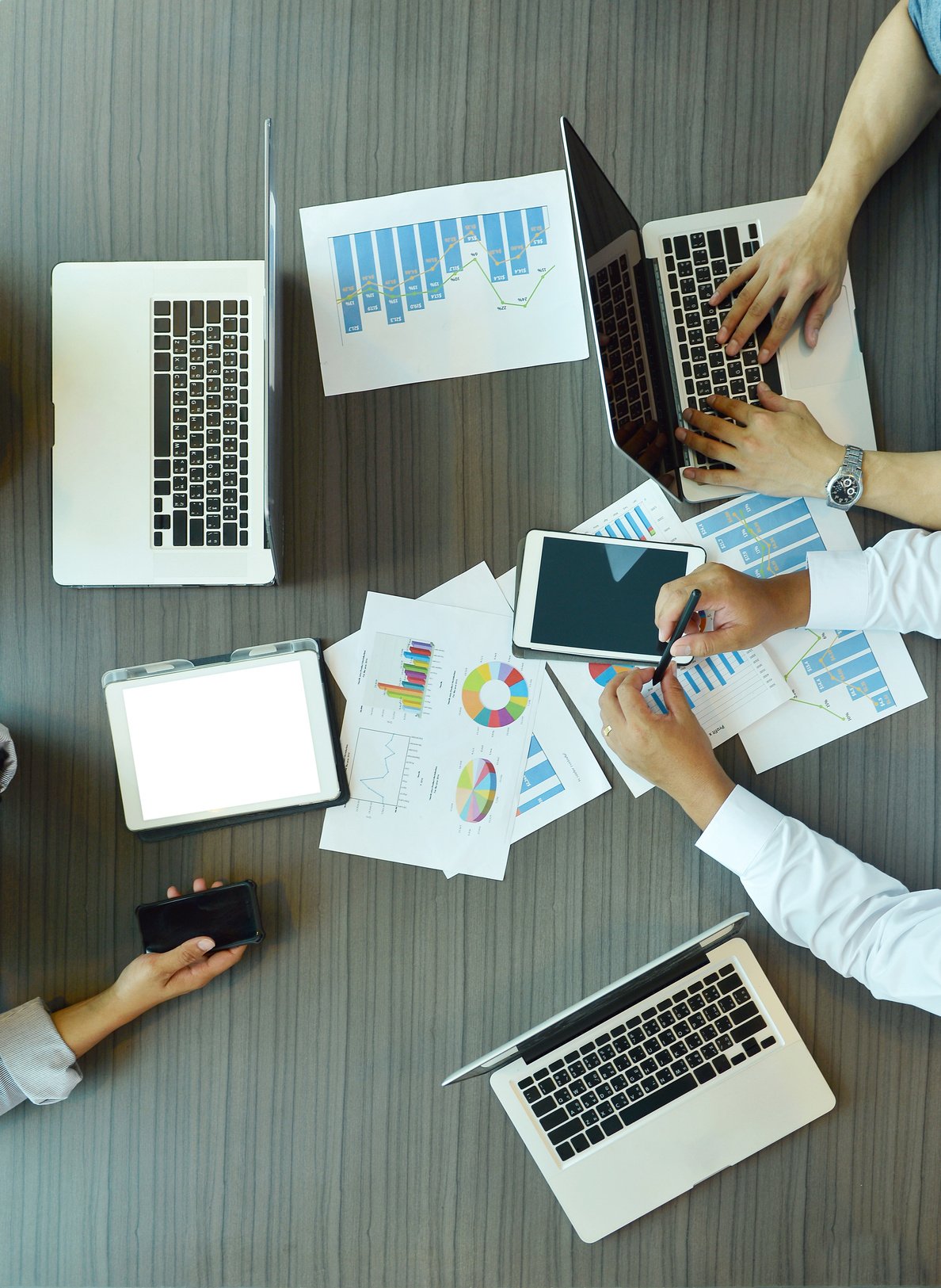 Top view of Technology equipment with tablet, laptop, business documents on meeting table